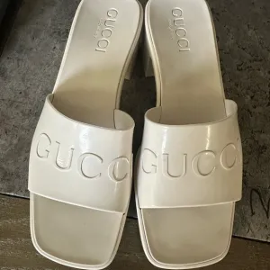Gucci Cream Mules with Embossed Logo